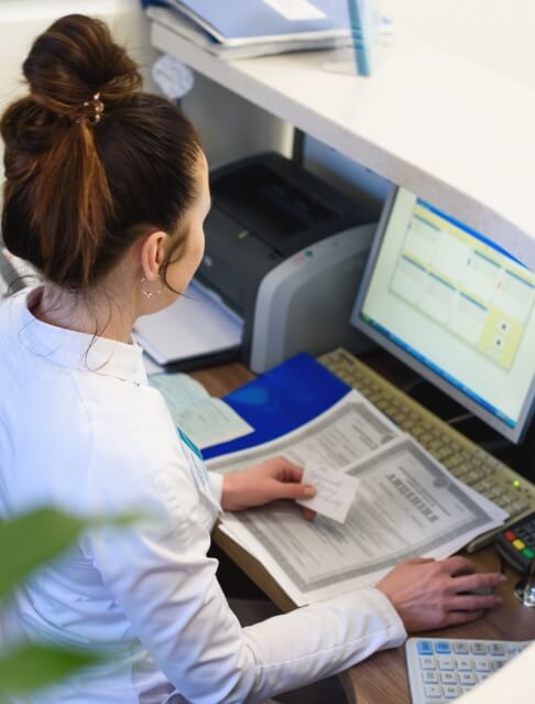 Dental team member looking at computer