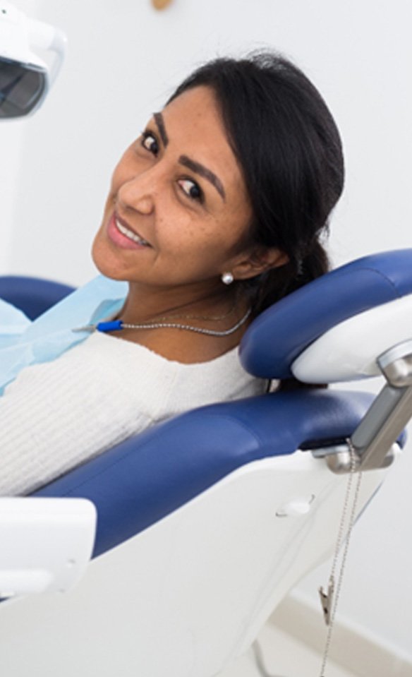 Female patient in chair waiting for dental checkup and cleaning in Castle Rock, CO