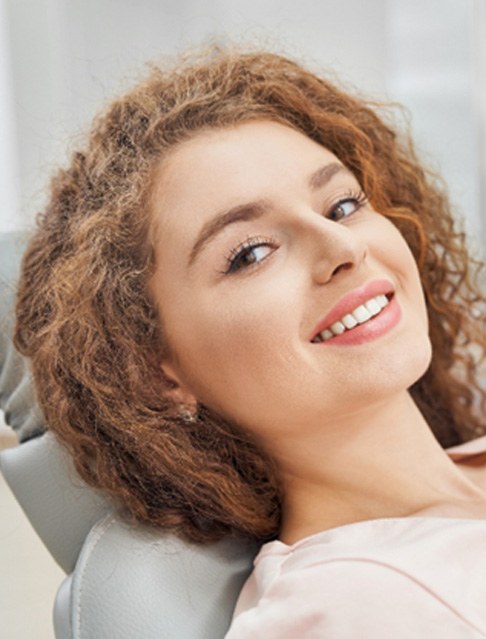 Woman leaning back in dental chair for dental checkup and cleaning in Castle Rock, CO