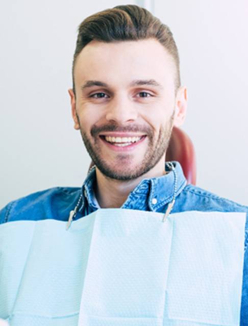 Man sitting in dental chair and smiling