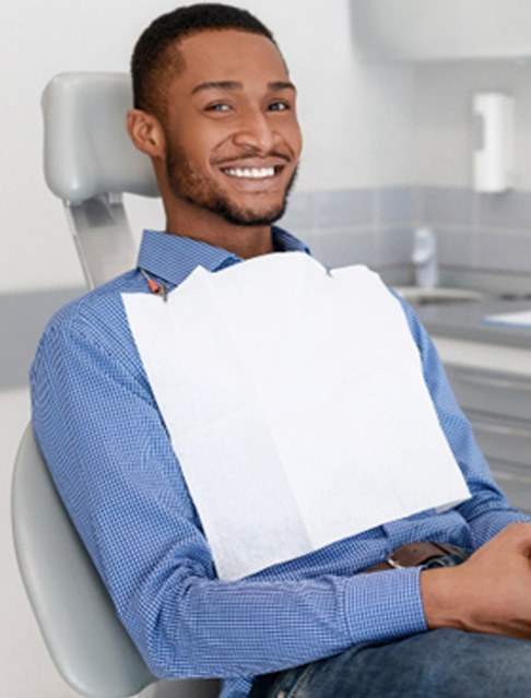 Man in dental chair after dental cleaning in Castle Rock, CO