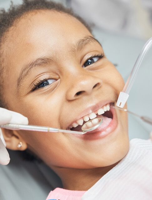 Child smiling during a dental exam