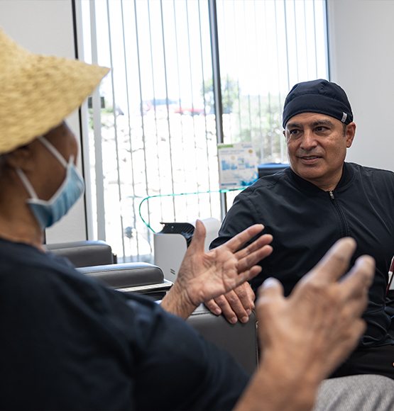 Doctor Lopez chatting with a dental patient