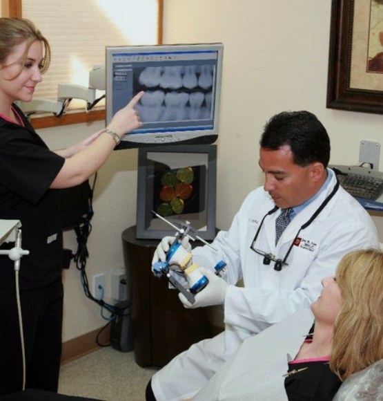 Doctor Lopez showing a model of the jaws to a dental patient