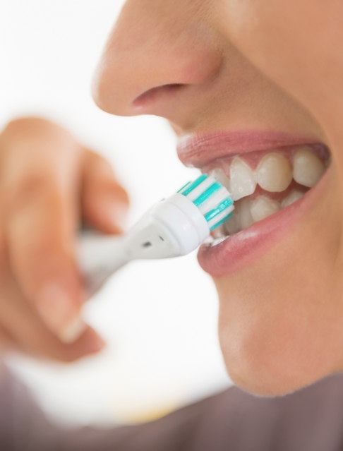 Close up of person brushing their teeth