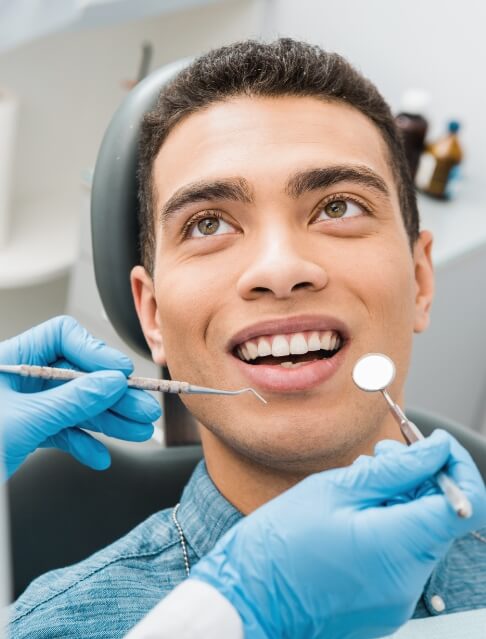 Man smiling at his dentist during a dental checkup