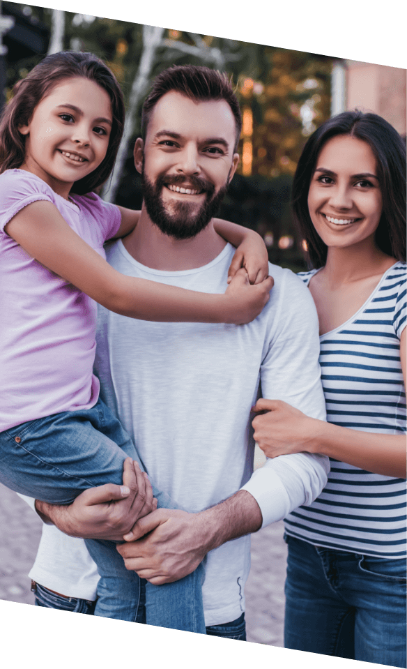 Family of three smiling after receiving dental services in Castle Rock