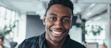 Man smiling inside an office