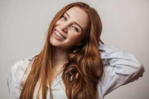 Young woman smiling with metal braces